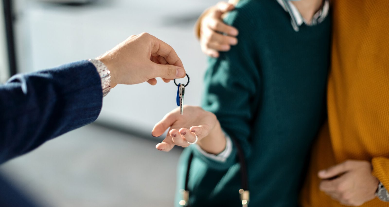 closeup couple receiving key their new real estate