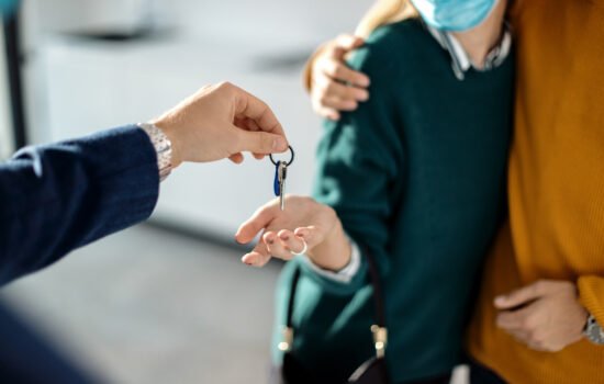 closeup couple receiving key their new real estate